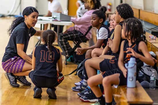 Kayla teaching kids basketball